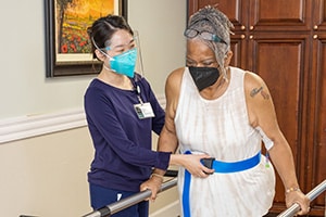 Pleasant Hill Post Acute - rehab therapist with a resident wearing masks